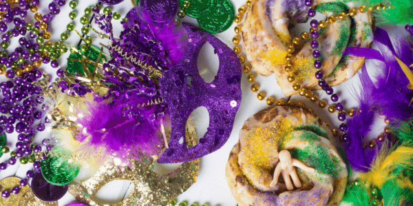 mardi gras decorations, beads, and king cake