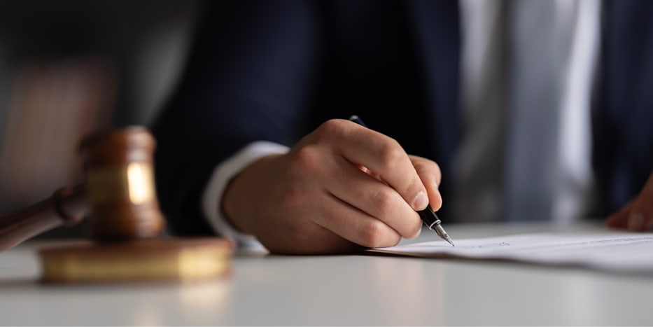 man writing on legal papers
