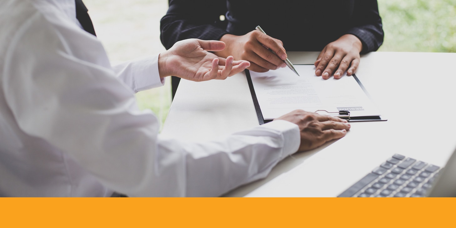 Two professionals pointing at insurance papers