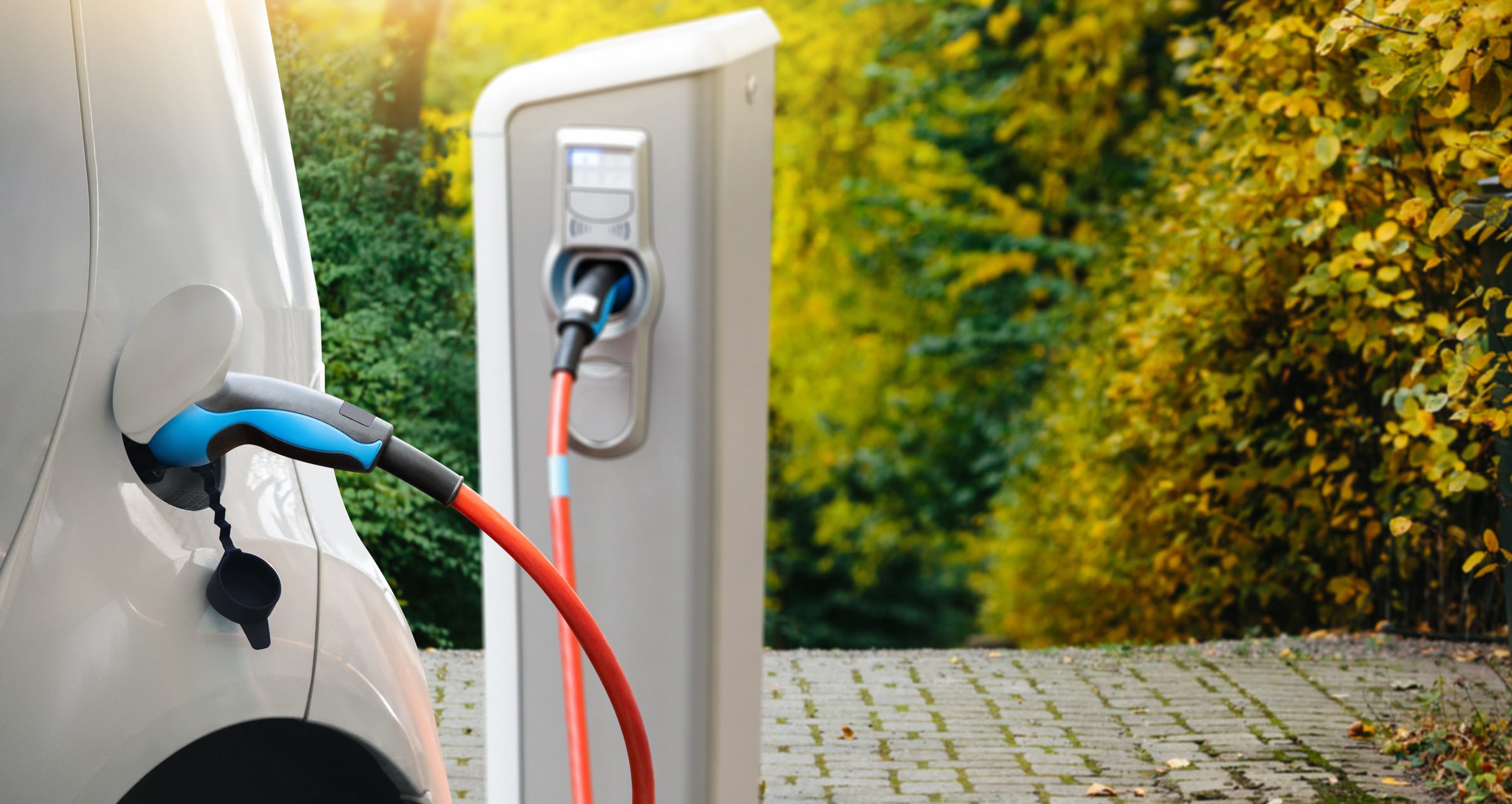 Electric vehicle charging port with pump inside of car.