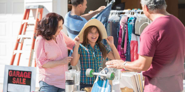 family trying on hats at garage sale 