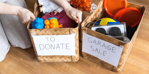 woman sorting items to donate or sell in garage sale