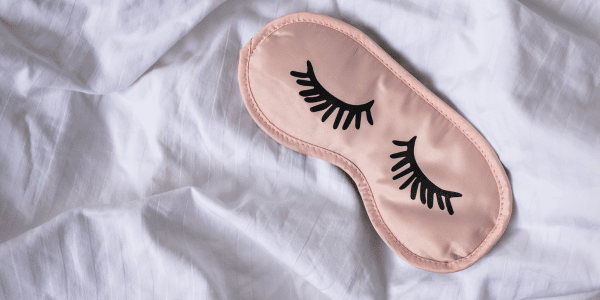 pink sleep mask on bed