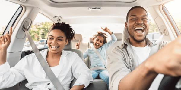 family of three playing road trip game in car