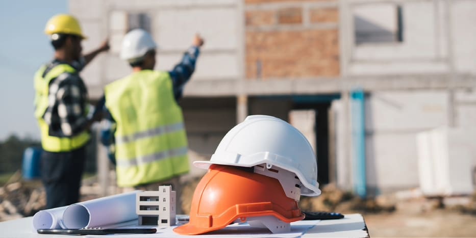 Construction workers facing a home that is under construction