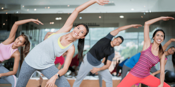 happy people doing group workout class
