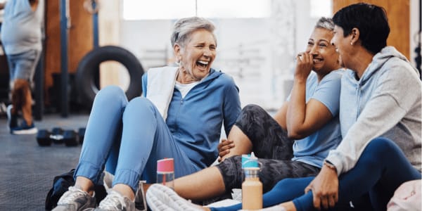 three women laughing at gym