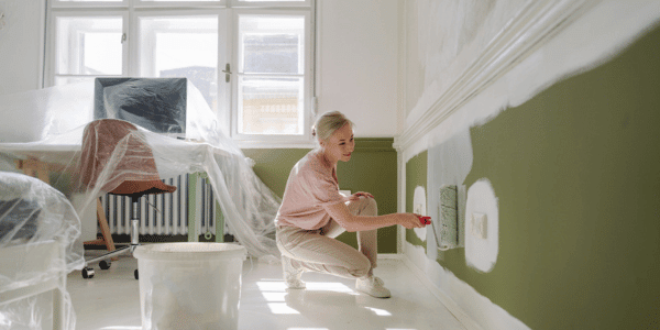 woman painting interior design room green