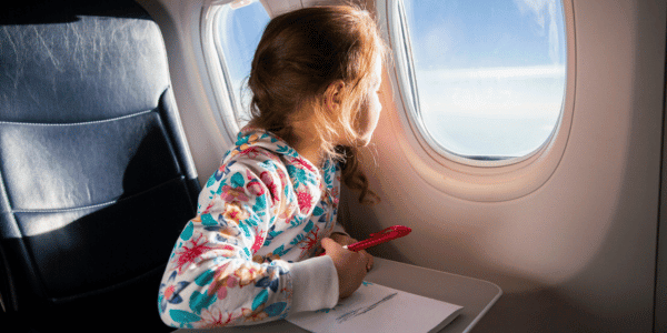 small child looking out airplane window