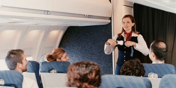 flight attendant doing safety demo on plane