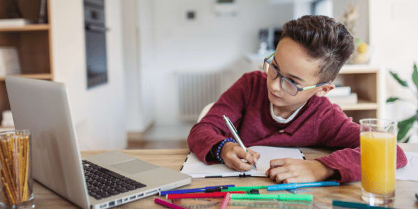 child doing homework at clean workspace after back to school decluttering