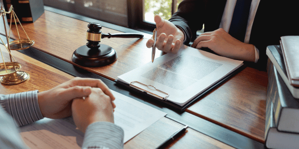 lawyer writing will for client in office
