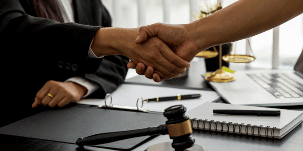 two people shaking hands after writing a will