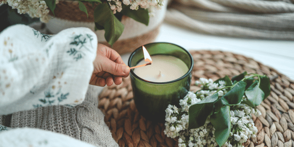 person in apartment lighting candle