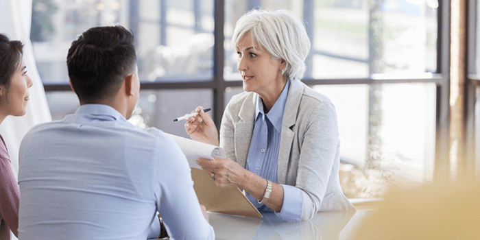 older woman has meeting with two young coworkers