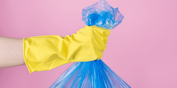 woman holding trash bag after cleaning trash can