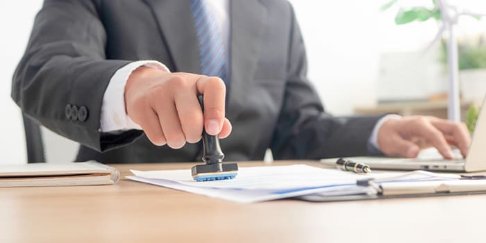 Businessman stamping a form