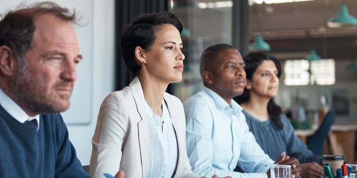 Businesspeople sitting in a boardroom meeting