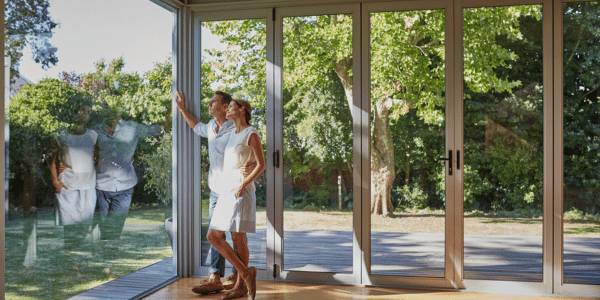 couple looking out new home replacement windows