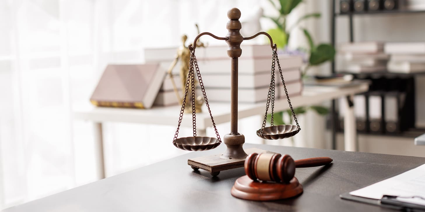 Justice scale and gavel sitting on a desk