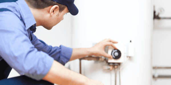 technician making hot water heater repairs