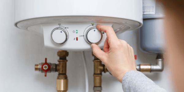 female adjusting hot water heater