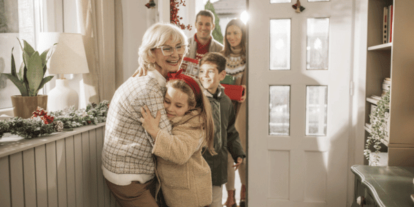 family hugging after neighborhood holiday party