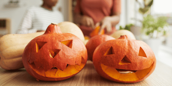 mother and son carving pumpkins for Halloween