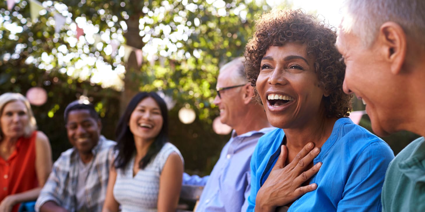 Homeowner and guests socializing in backyard