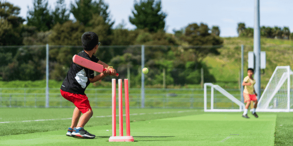 two children playing the game of cricket