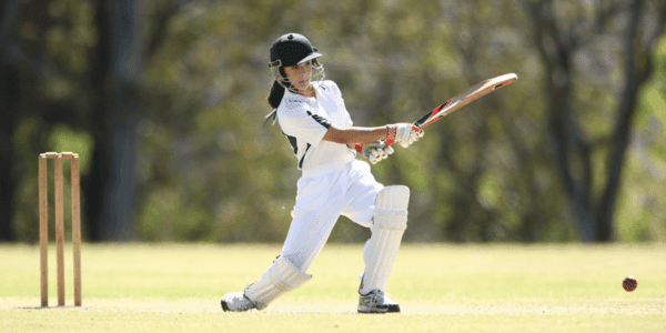 female playing cricket game