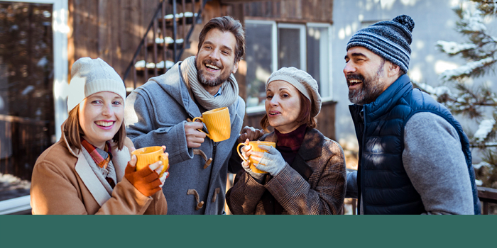 Homeowners enjoying hot chocolate at an outdoor holiday event