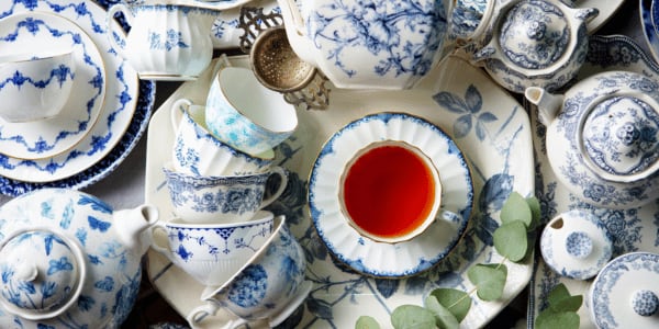 A cup of tea among English-style fine china tea drinking utensils.