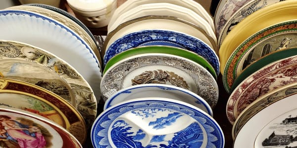 stacks of fine china plates at antique store