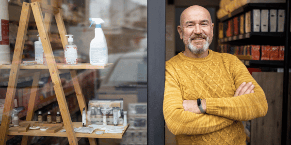 local small business owner standing in front of his shop on Small Business Saturday