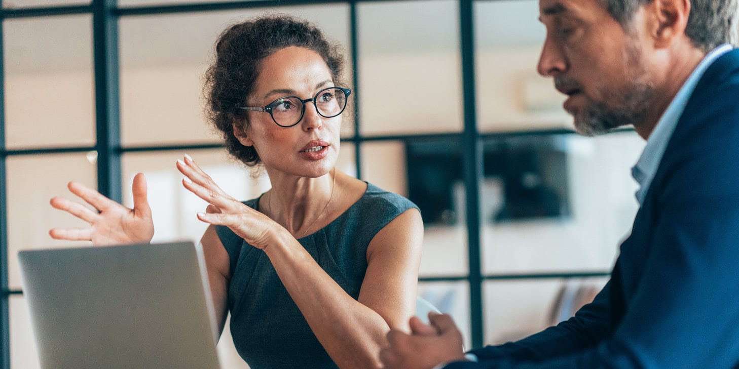 Woman speaking to a man one-on-one in a business/office setting