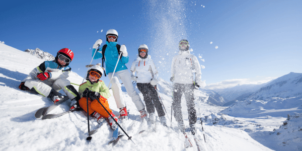 family of five skiing on mountain
