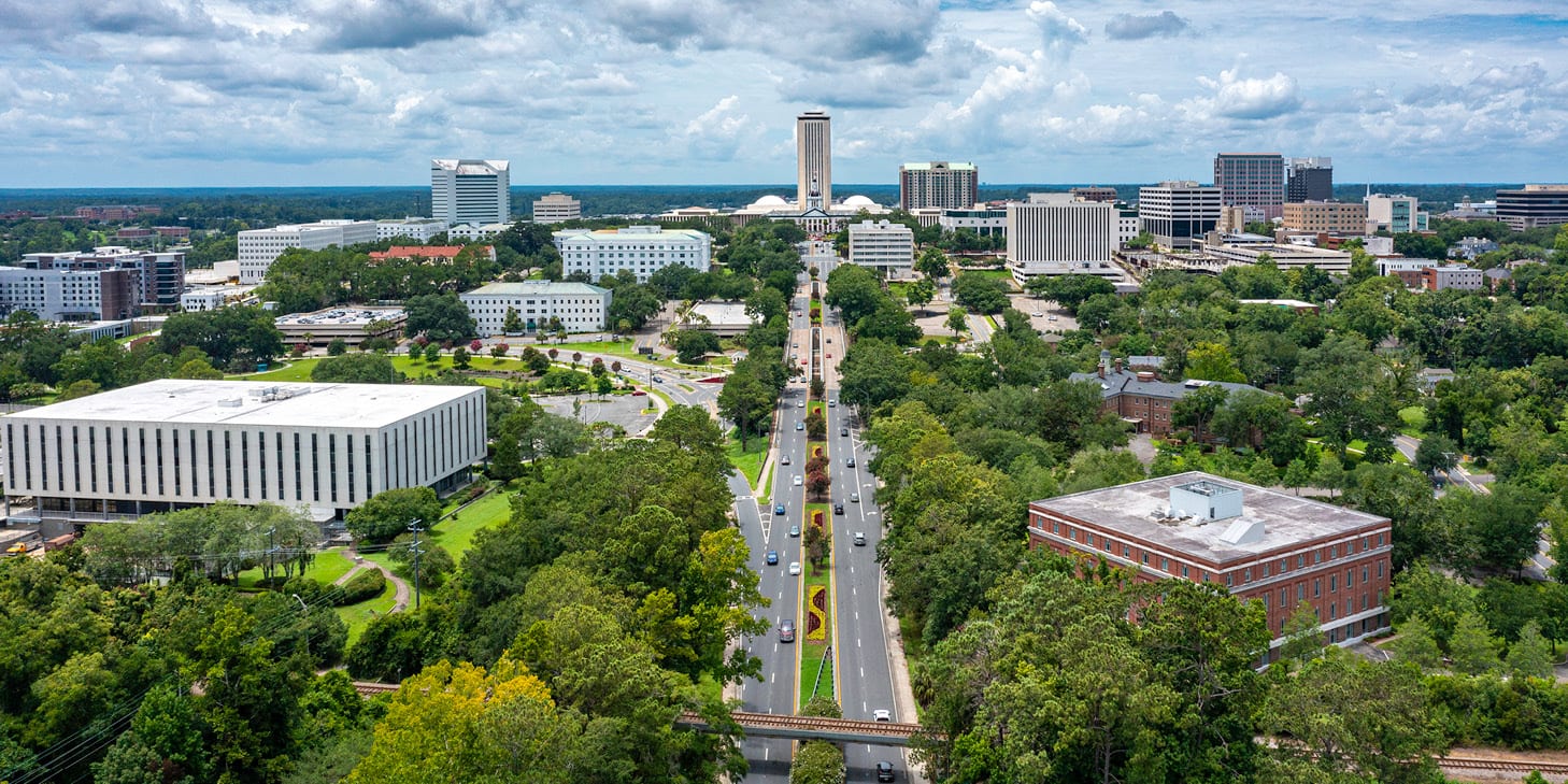 Drone view of the Florida state capitol in Tallahassee, FL with the city skyline.