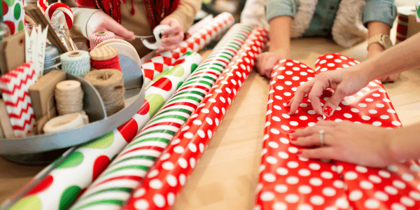woman wrapping holiday gifts 