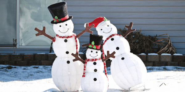 three wire snowmen outside of home in winter