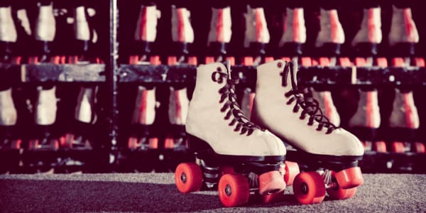 retro roller skates in white with red wheels
