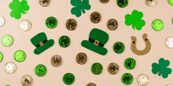 gold coins, horseshoes, and leprechaun hat confetti scattered for St. Patrick's Day