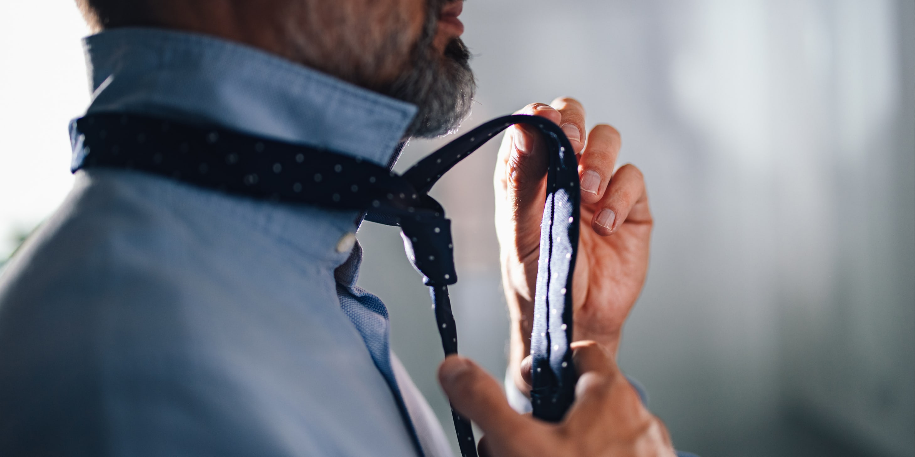 Close-up of a man tying a tie 