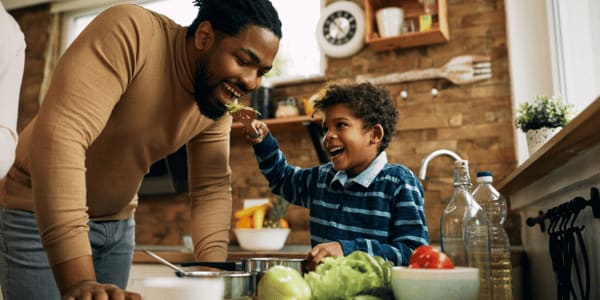 man cooking with his son in kitchen