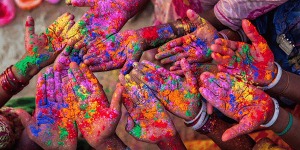 children celebrating Holi with colorful hands