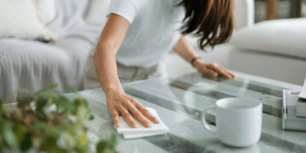 young woman cleaning dust in home