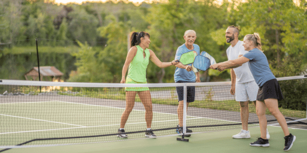 four neighbors finishing pickleball game