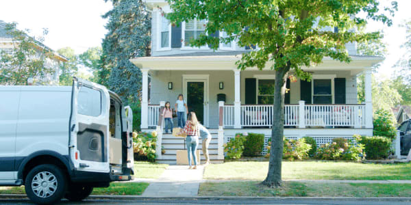 children helping parents unpack new HOA home