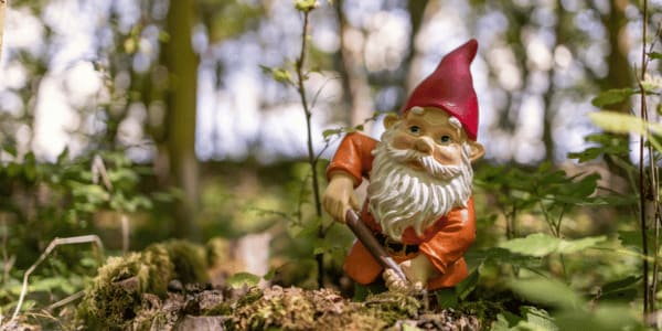garden gnome digging in the forest