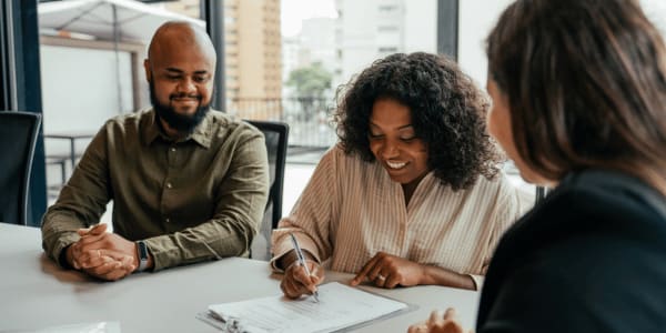 couple signing HOA vendor service contract